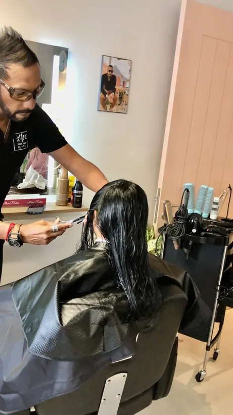 Kris cutting long dark hair
